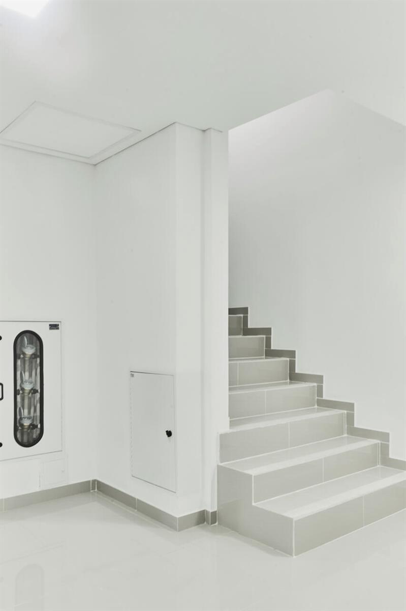 A minimalist white interior features a staircase with light gray tiled steps and walls — Carrera 47 Numero 64 45, 00000, FL