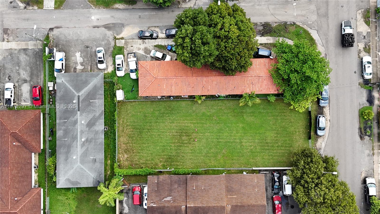 An aerial view shows a rectangular grassy lot situated between two buildings and a street — 1941 NW 19th Ave, Miami FL 33125, MIAMI, FL