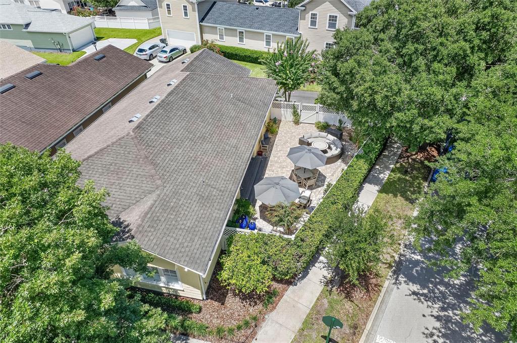 An aerial view shows a house with a paved patio, outdoor furniture, and surrounding landscaping — 920 PAWSTAND ROAD, CELEBRATION, FL