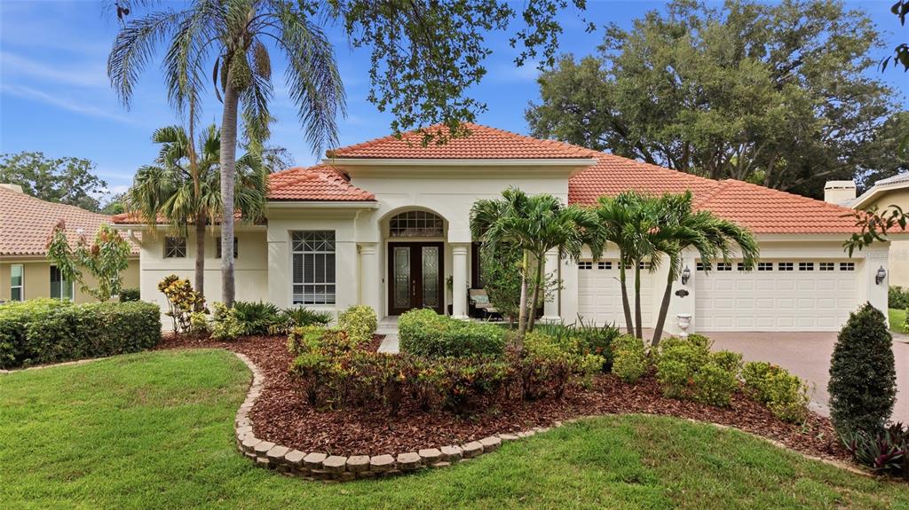 A backyard featuring a swimming pool, a hot tub, and a paved patio area — 3459 WOODRIDGE PARKWAY, PALM HARBOR, FL