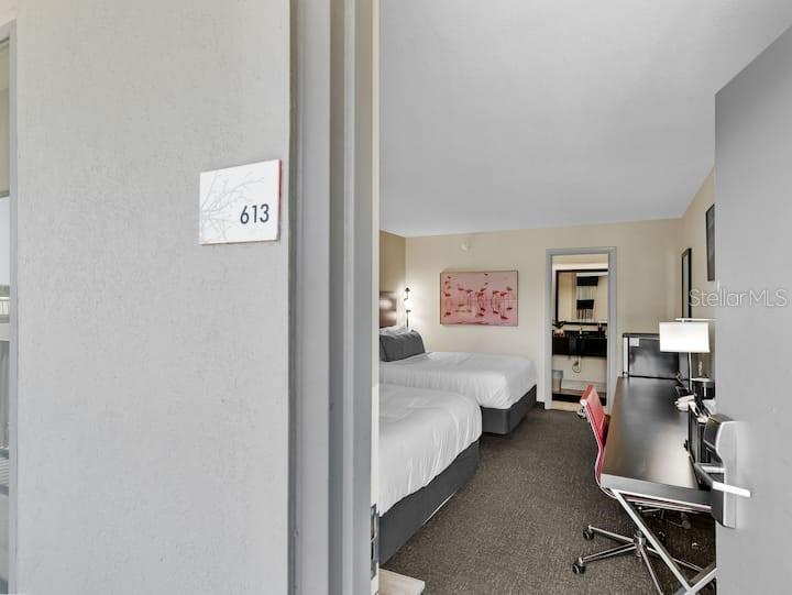A hotel room with two beds, a desk, and a bathroom visible through the doorway — 7150 N TAMIAMI TRAIL UNIT S-613, SARASOTA, FL