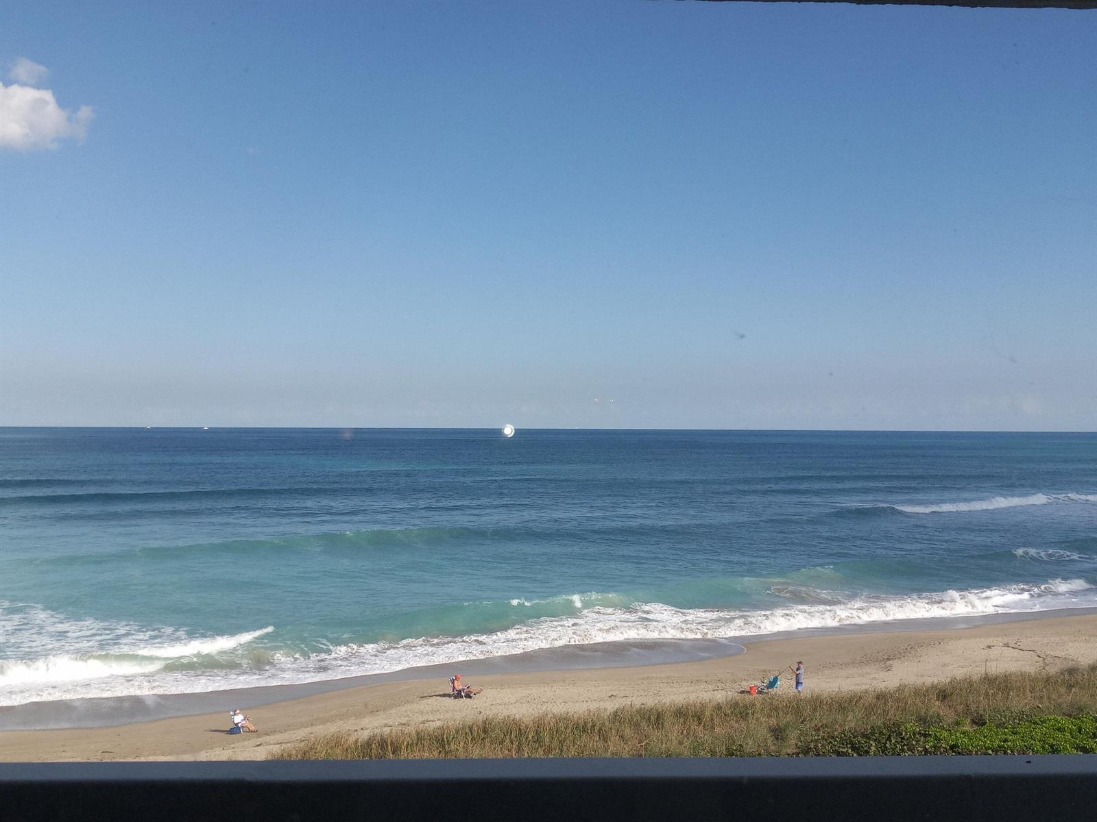 A view of a sandy beach and the ocean from an elevated balcony — 9960 S Ocean Drive # 502, Jensen Beach FL 34957, JENSEN BEACH, FL