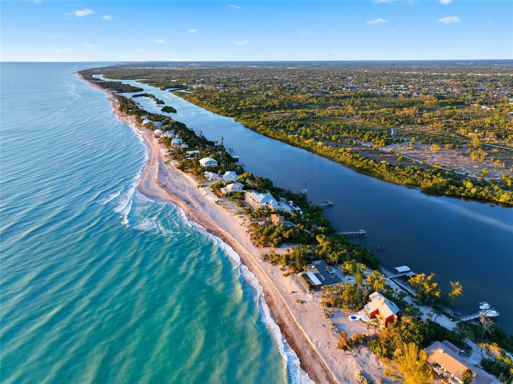 An aerial view of a narrow barrier island with beachfront homes along a coastal waterway — 765 N MANASOTA KEY ROAD, ENGLEWOOD, FL