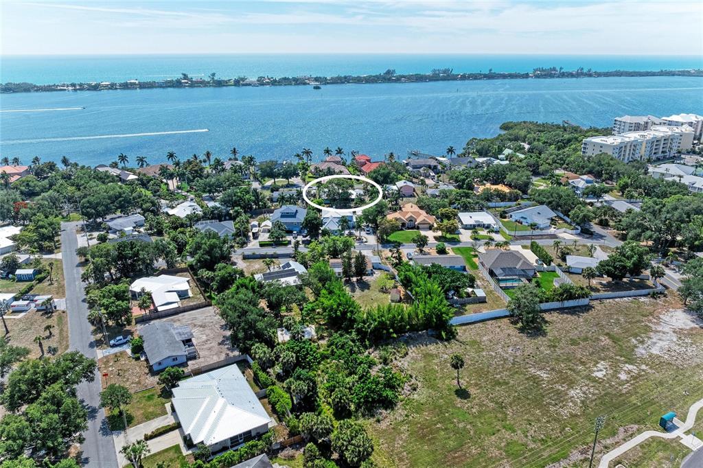 An aerial view shows a residential neighborhood near a large body of water — 347 BAYSHORE DRIVE, OSPREY, FL