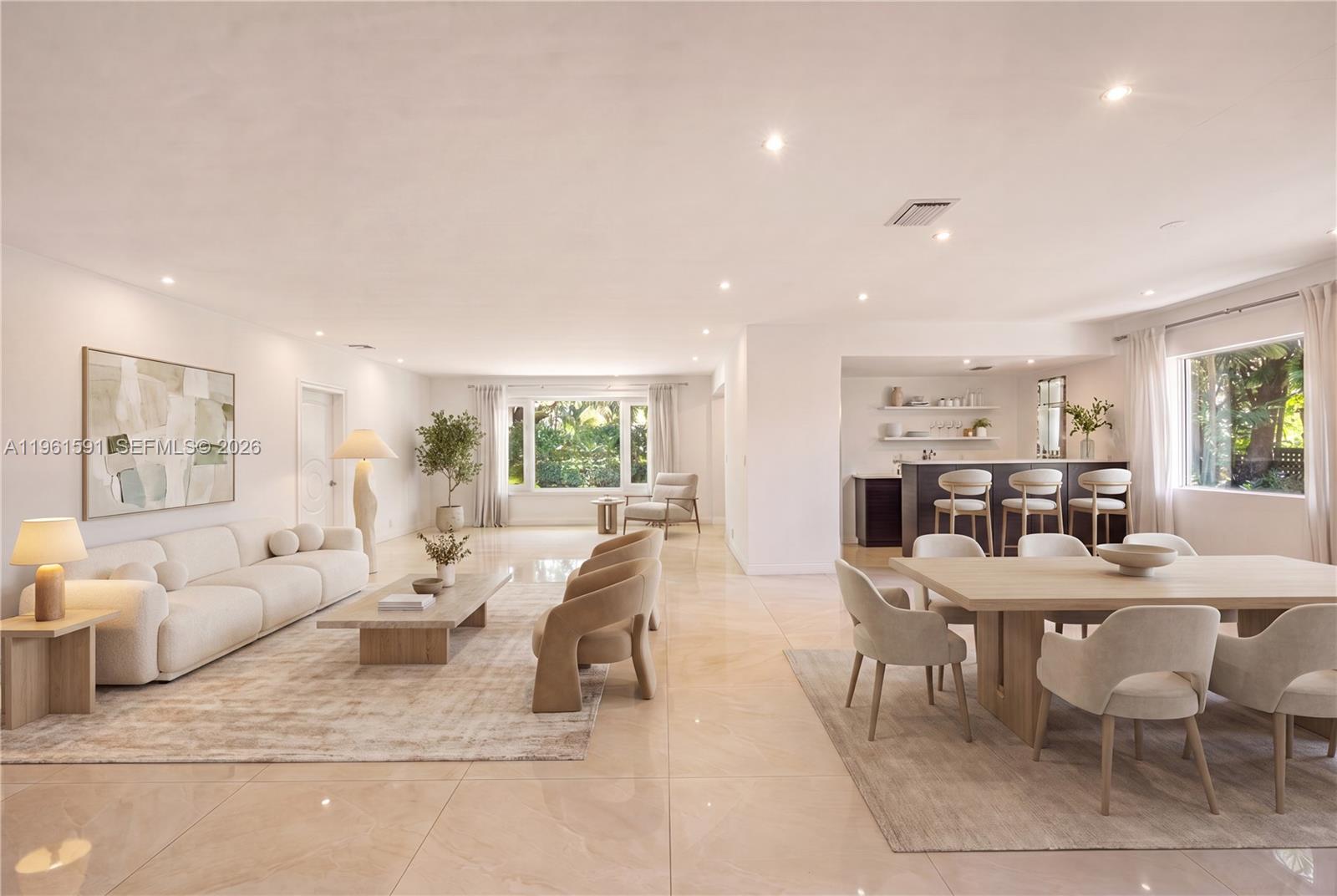 A white single-story house features a paved driveway, front steps, and mature landscaping — 1101 Coral Way, Coral Gables FL 33134, CORAL GABLES, FL