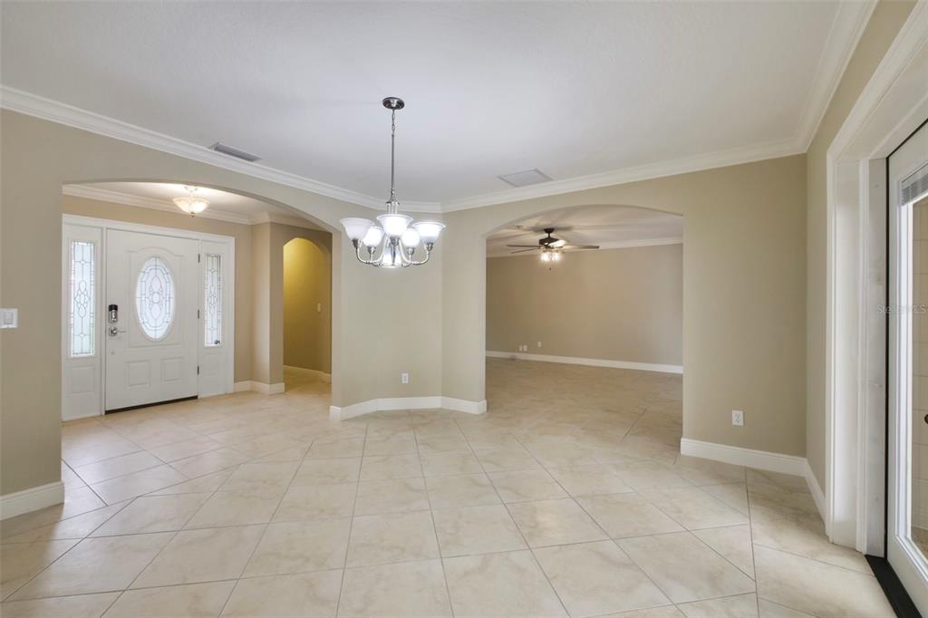 A dining room with a marble-topped table, six chairs, a sideboard, and French doors — 110 LONGHORN ROAD, WINTER PARK, FL