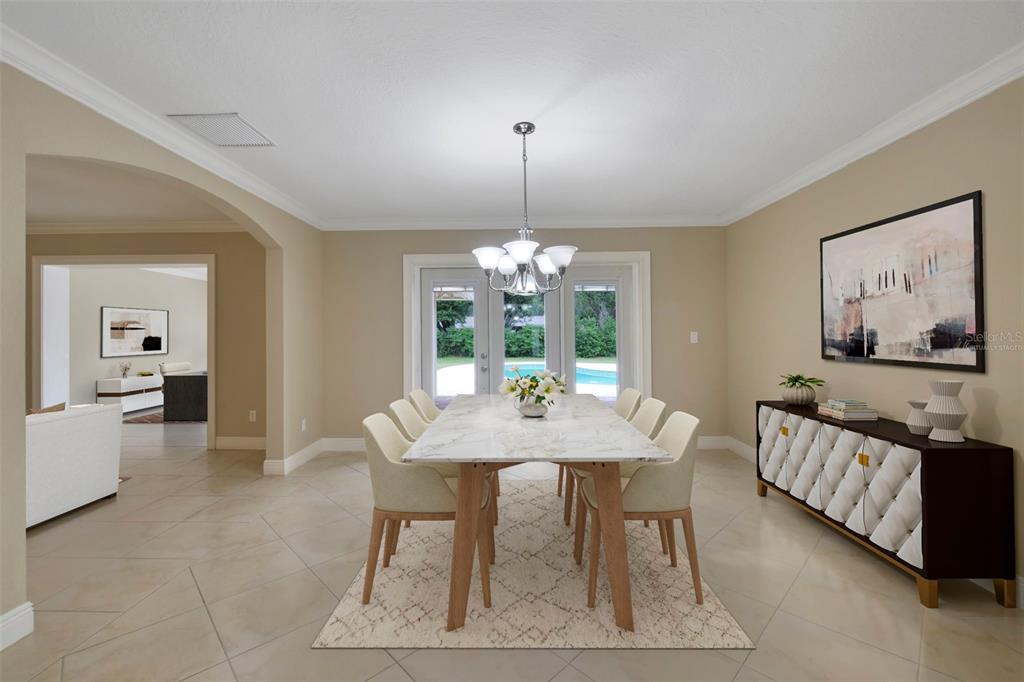 A dining room with tile flooring, a chandelier, and glass doors leading to a patio — 110 LONGHORN ROAD, WINTER PARK, FL