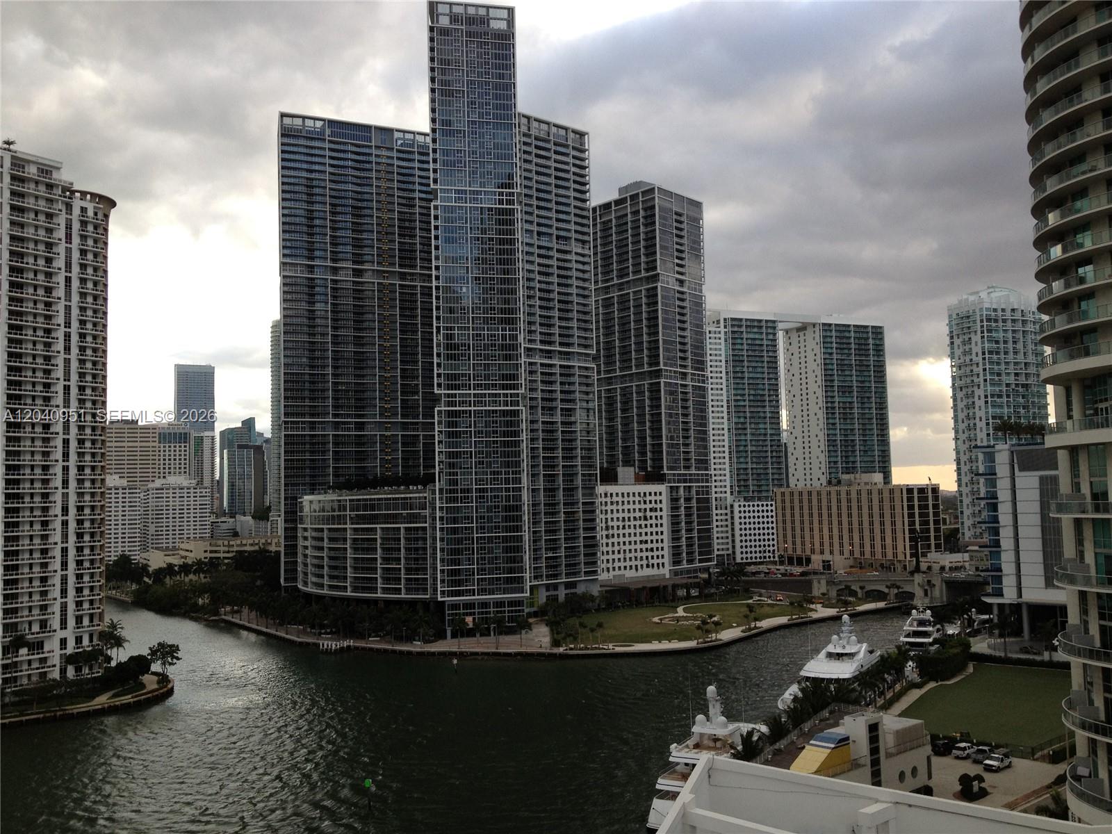An elevated view of a Miami waterfront featuring modern high-rise buildings and docked yachts — 325 S Biscayne Blvd # 1414, Miami FL 33131, MIAMI, FL
