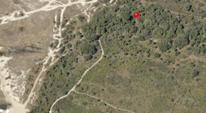 This aerial view shows a red map pin marking a wooded area near dirt paths — 0 NW 306th Street, Okeechobee FL 34972, OKEECHOBEE, FL