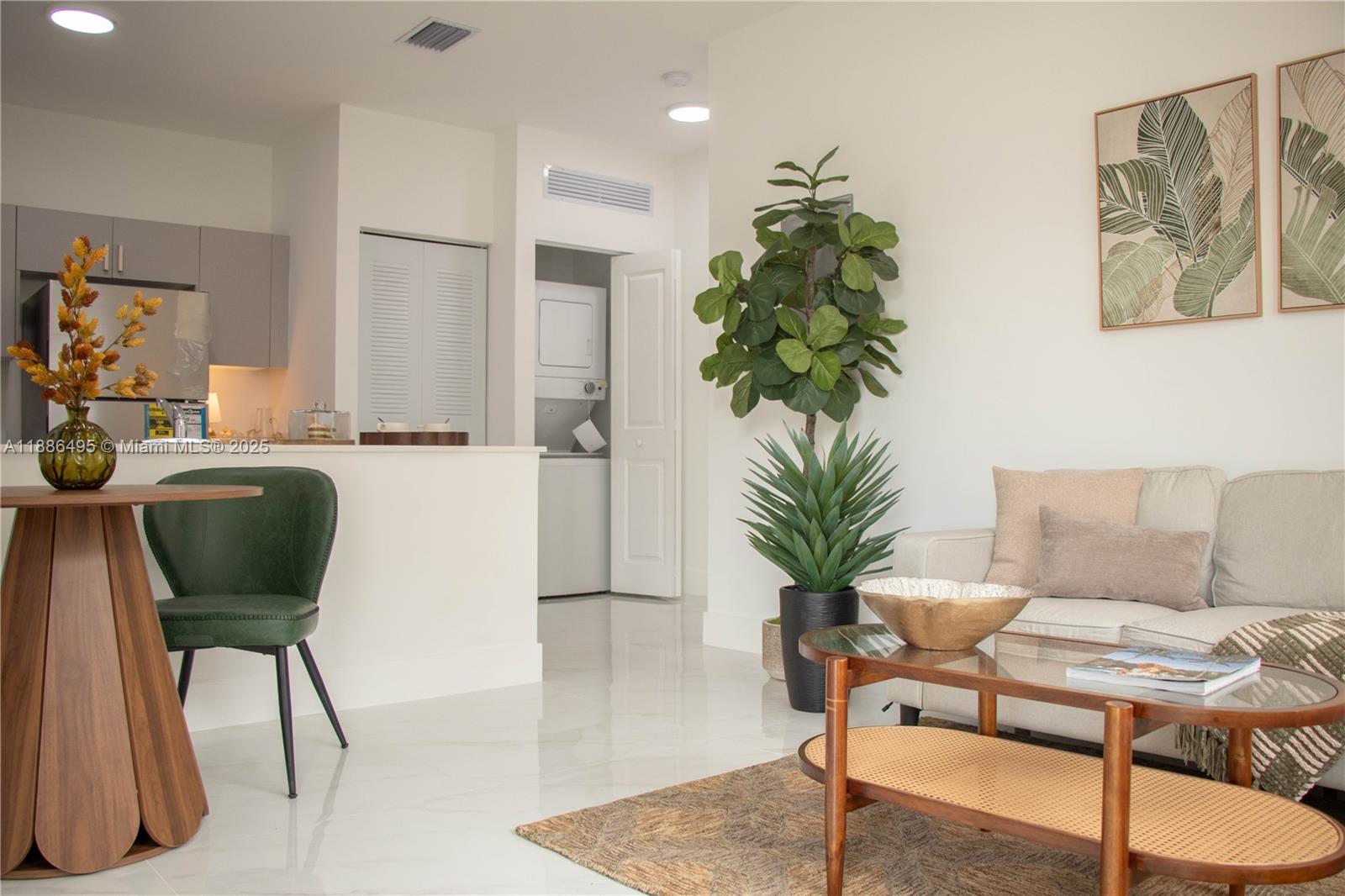 This living room features a sofa, a dining area, and an adjacent laundry closet — 1453 W 29th St # 307, Hialeah FL 33012, HIALEAH, FL