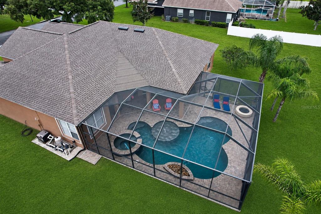 An aerial view of a house with a screened-in pool, spa, and patio area — 2813 HAMPTON PLACE COURT, PLANT CITY, FL