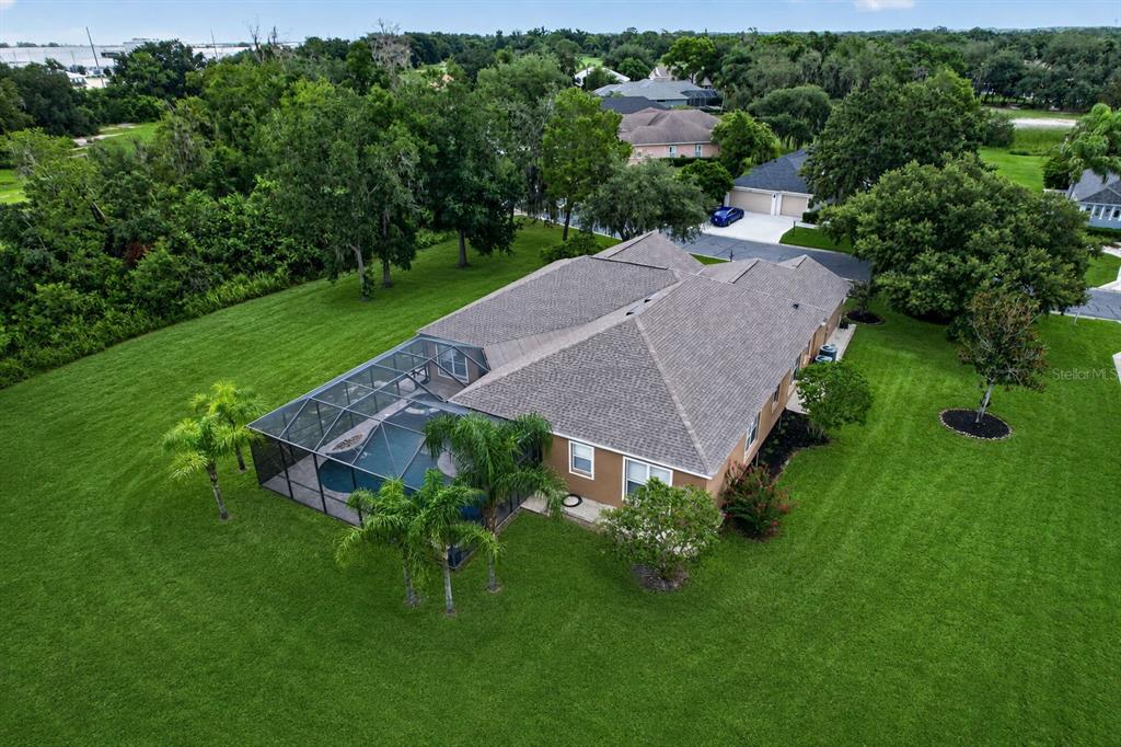 An aerial view shows a house with a screened-in pool and a large grassy yard — 2813 HAMPTON PLACE COURT, PLANT CITY, FL