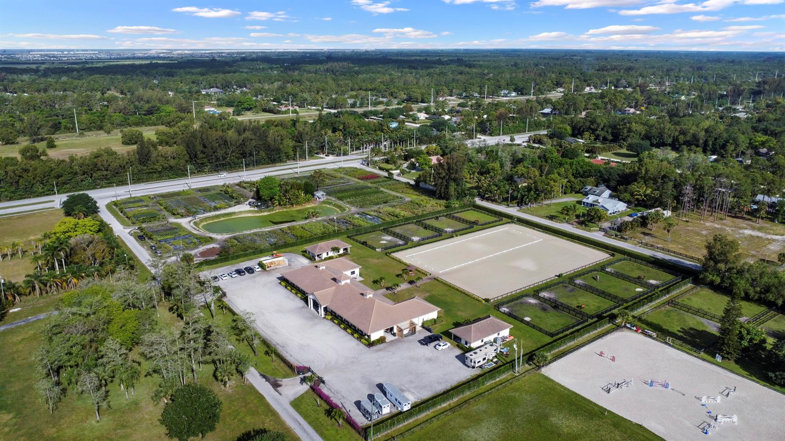 An aerial view shows a horse farm with a main house, riding arenas, and paddocks — 16575 Van Gogh Road, Wellington FL 33414, WELLINGTON, FL