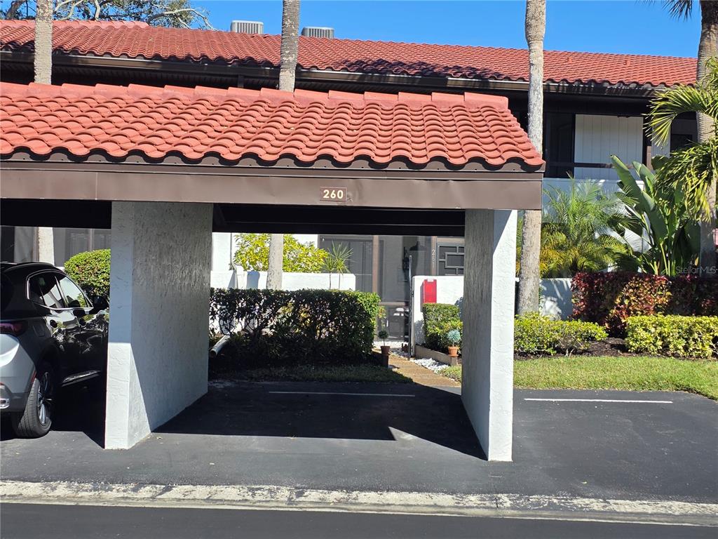 A covered carport with a red tile roof and the number 260 displayed above — 3500 EL CONQUISTADOR PARKWAY UNIT 260, BRADENTON, FL