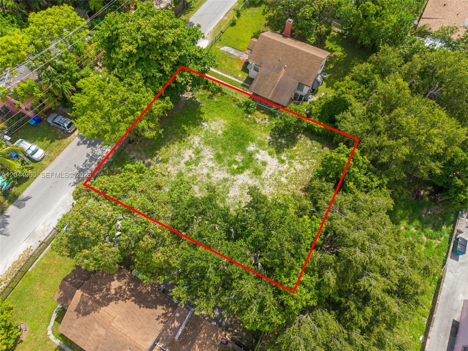 An aerial view shows a vacant, rectangular residential lot outlined in red — 60 NE 76th St, Miami FL 33138, MIAMI, FL