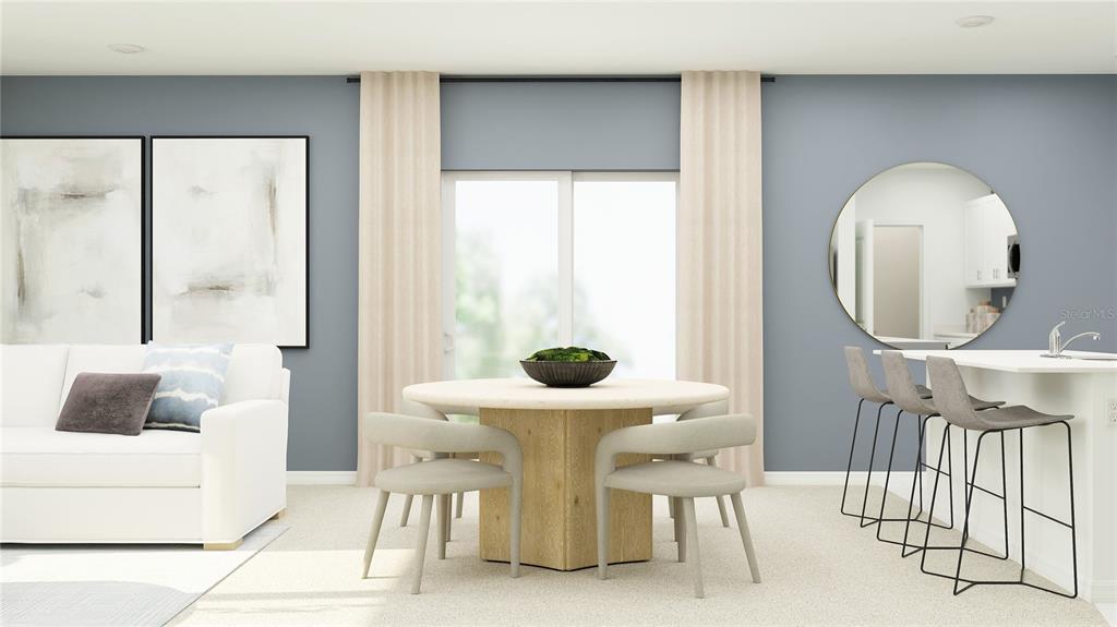 This digital rendering shows an open-concept dining area with a round table and kitchen island — 10623 SAGE CANYON DRIVE, RIVERVIEW, FL