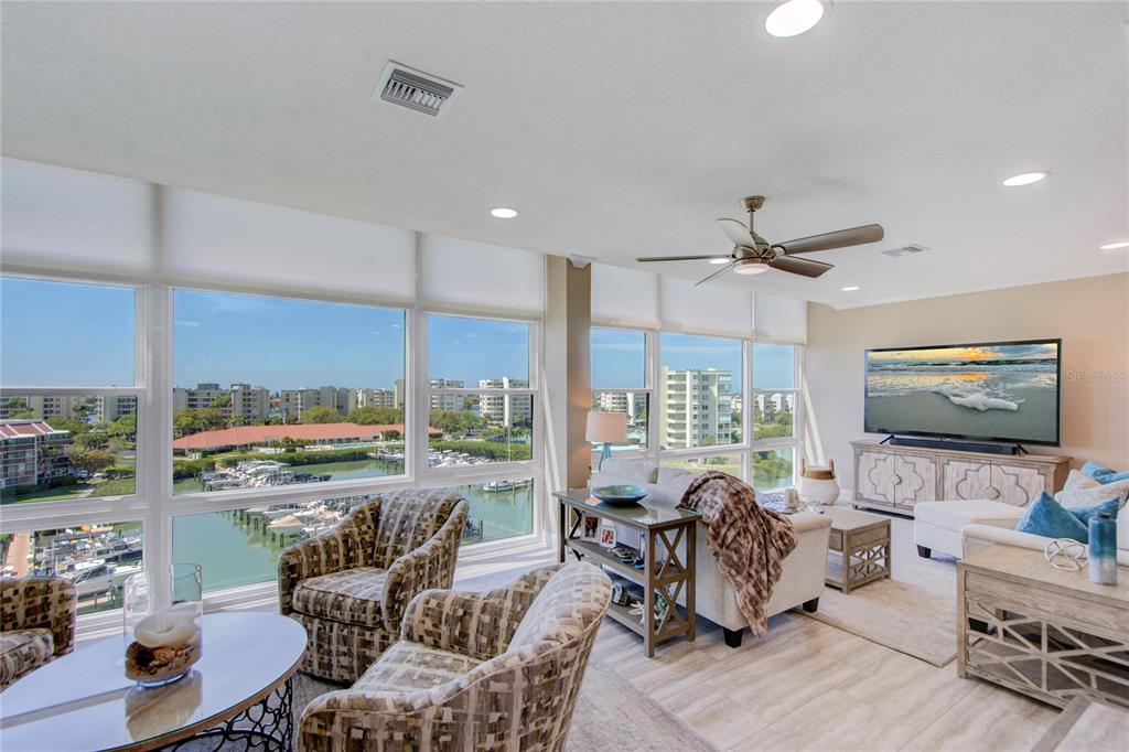 A tall apartment building stands beside a canal with a boat docked at a pier — 7600 SUN ISLAND DRIVE S UNIT 804, SOUTH PASADENA, FL