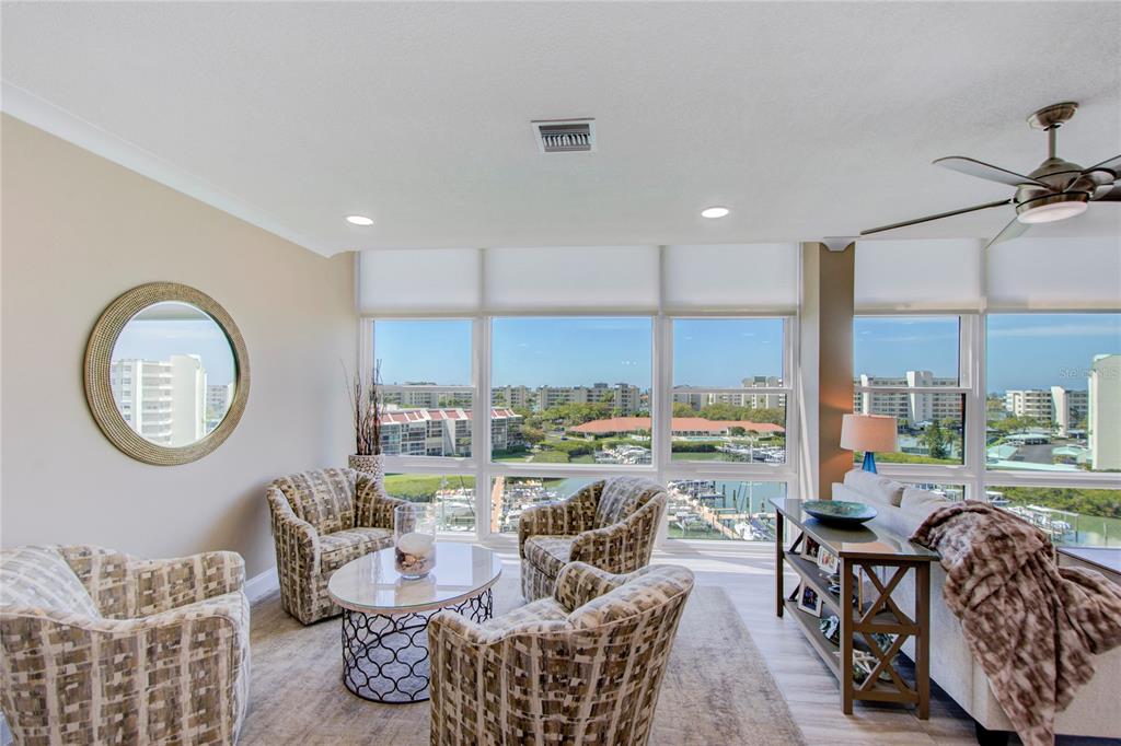 A bright entryway features a white door, a console table, a wardrobe, and a chair — 7600 SUN ISLAND DRIVE S UNIT 804, SOUTH PASADENA, FL