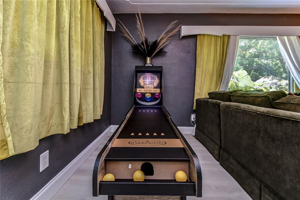 A Barrington Roll and Score game sits in a room with yellow curtains and flooring — 4701 N WILLIS STREET, TAMPA, FL