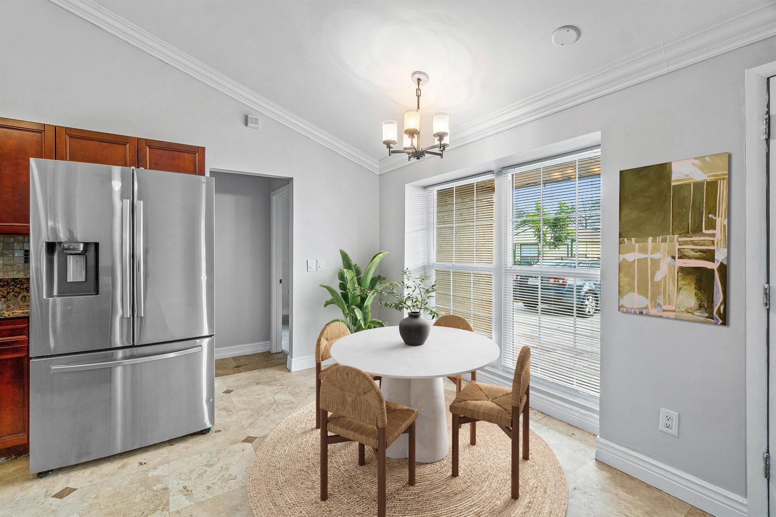 A dining area features a round white table, four woven chairs, and a stainless refrigerator — 8411 Garden Gate Place, Boca Raton FL 33433, BOCA RATON, FL