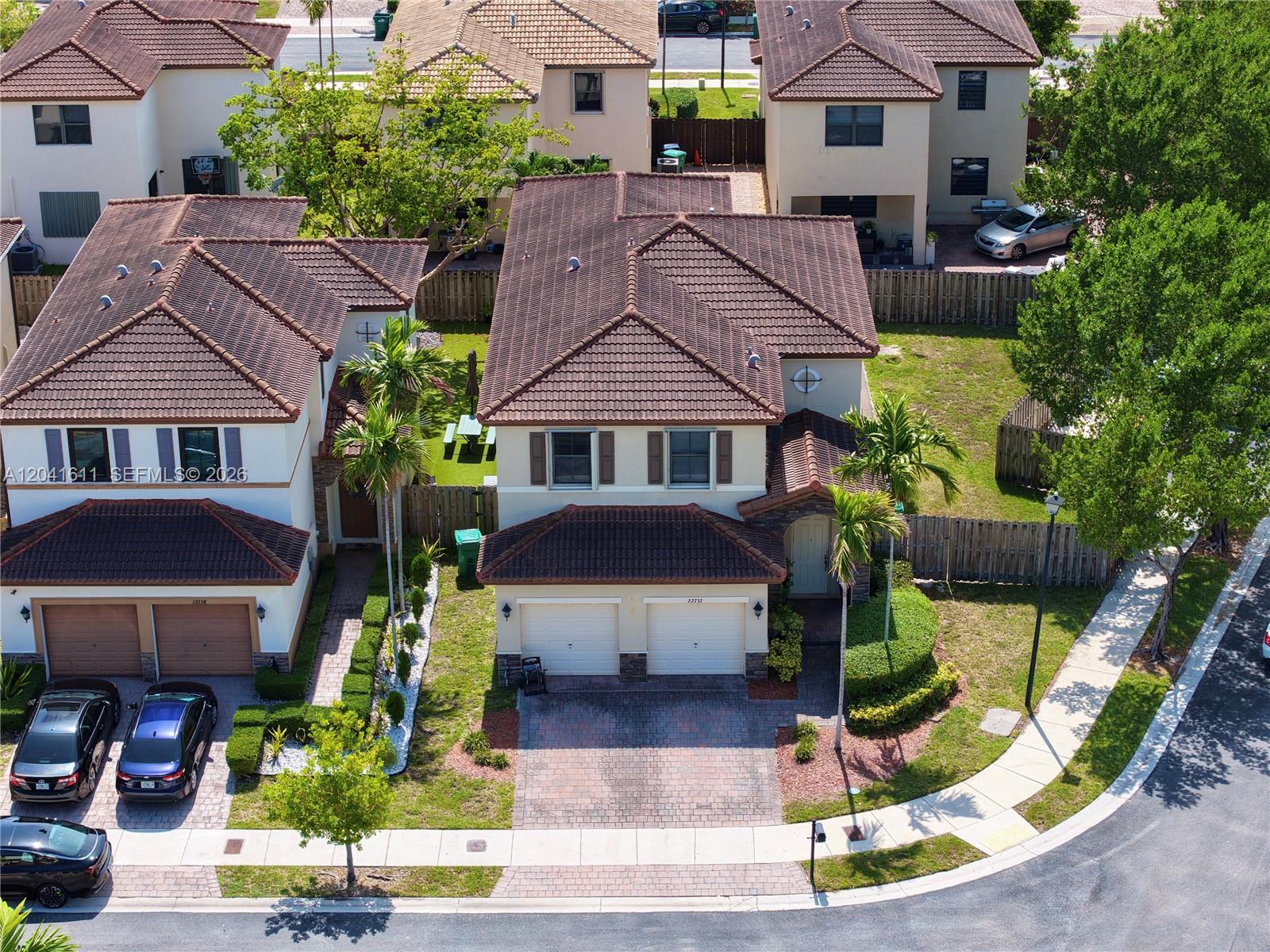 An aerial view shows two adjacent two-story houses with tiled roofs and attached garages — 22732 SW 92nd Pl, Cutler Bay FL 33190, CUTLER BAY, FL