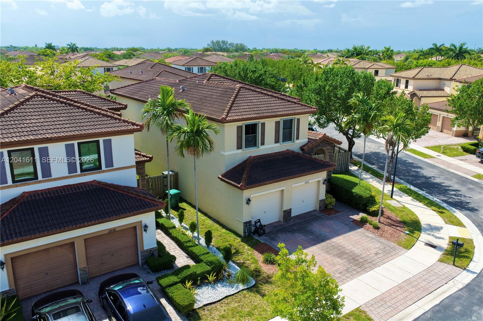 An aerial view shows two-story suburban houses with tile roofs, paved driveways, and palm trees — 22732 SW 92nd Pl, Cutler Bay FL 33190, CUTLER BAY, FL