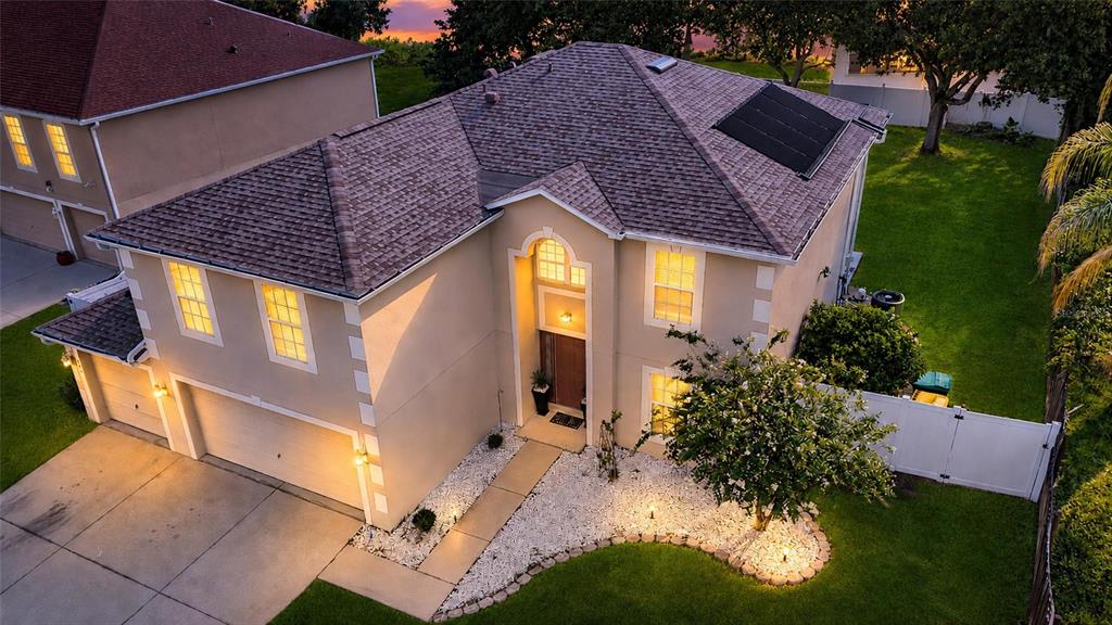 An aerial view of a two-story suburban house with a garage and a fenced yard — 1702 FOREST GLEN DRIVE, FRUITLAND PARK, FL
