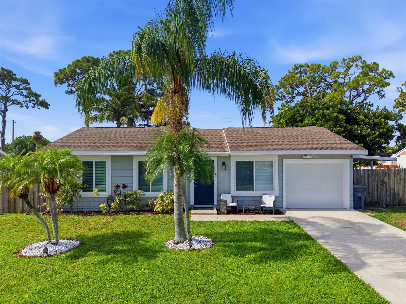 A single-story house with a light gray exterior, a front lawn, and two palm trees — 5396 Benjamin Avenue, Boynton Beach FL 33472, BOYNTON BEACH, FL