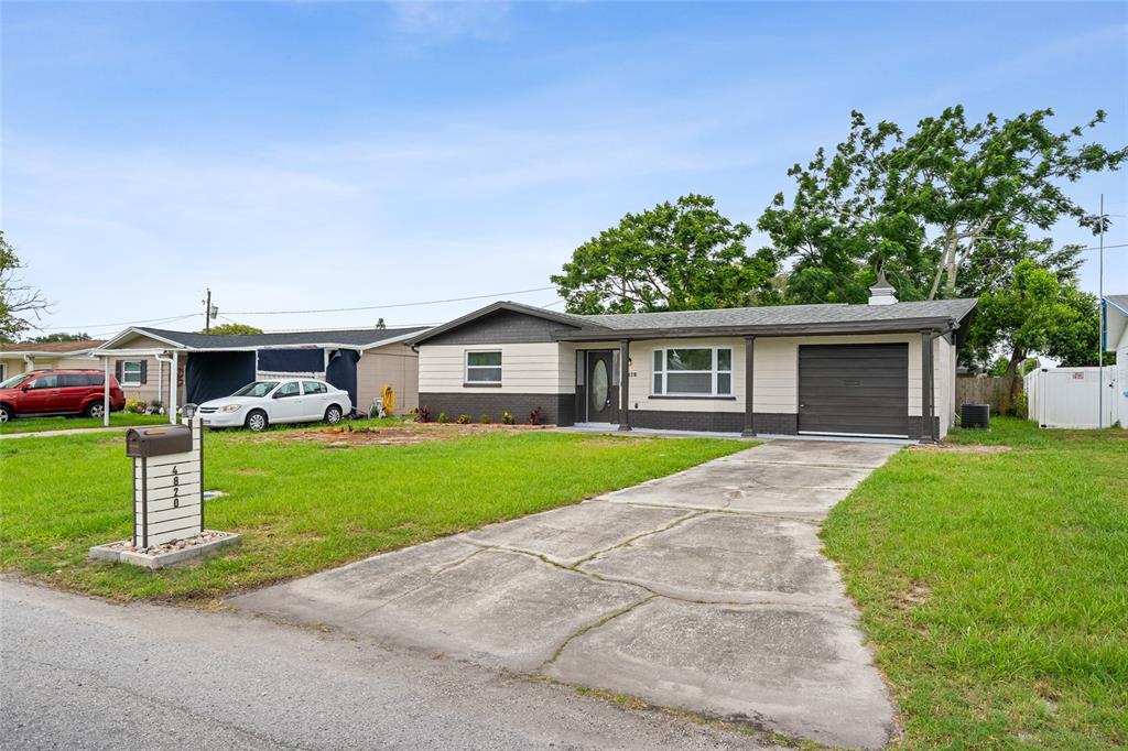 A single-story house with a concrete driveway, a garage, and a front lawn — 4820 SALEM DRIVE, NEW PORT RICHEY, FL