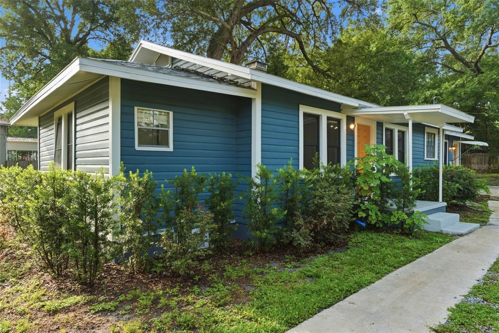 A blue-sided house with white trim and a concrete walkway leading to the front entrance — 2206 PAGE AVENUE, ORLANDO, FL