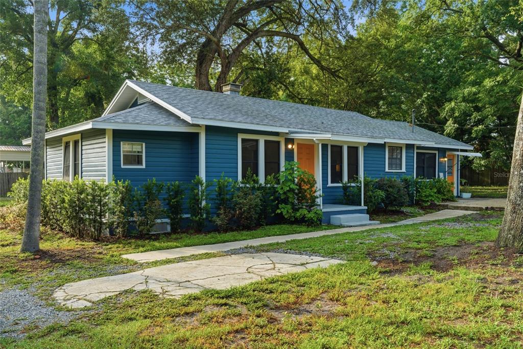 A blue, single-story house with a gray shingled roof and a concrete walkway — 2206 PAGE AVENUE, ORLANDO, FL
