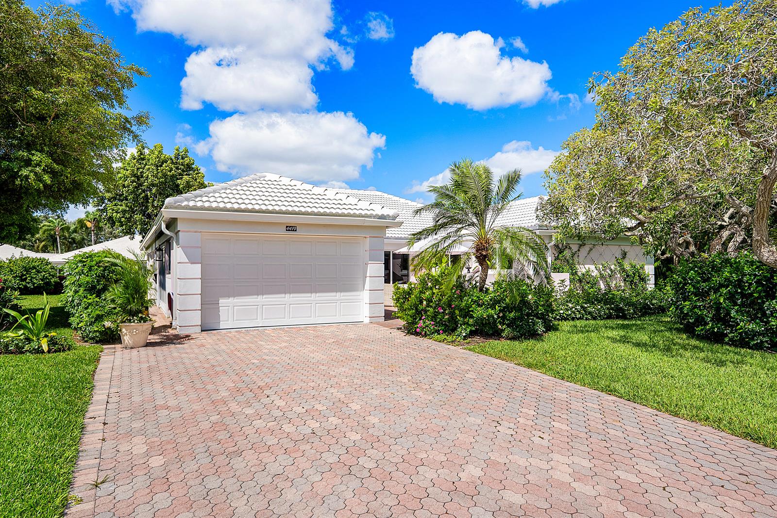 A single-story house with a white garage, tiled roof, and a paved driveway — 4419 E Sanderling Cir, Boynton Beach FL 33436, BOYNTON BEACH, FL