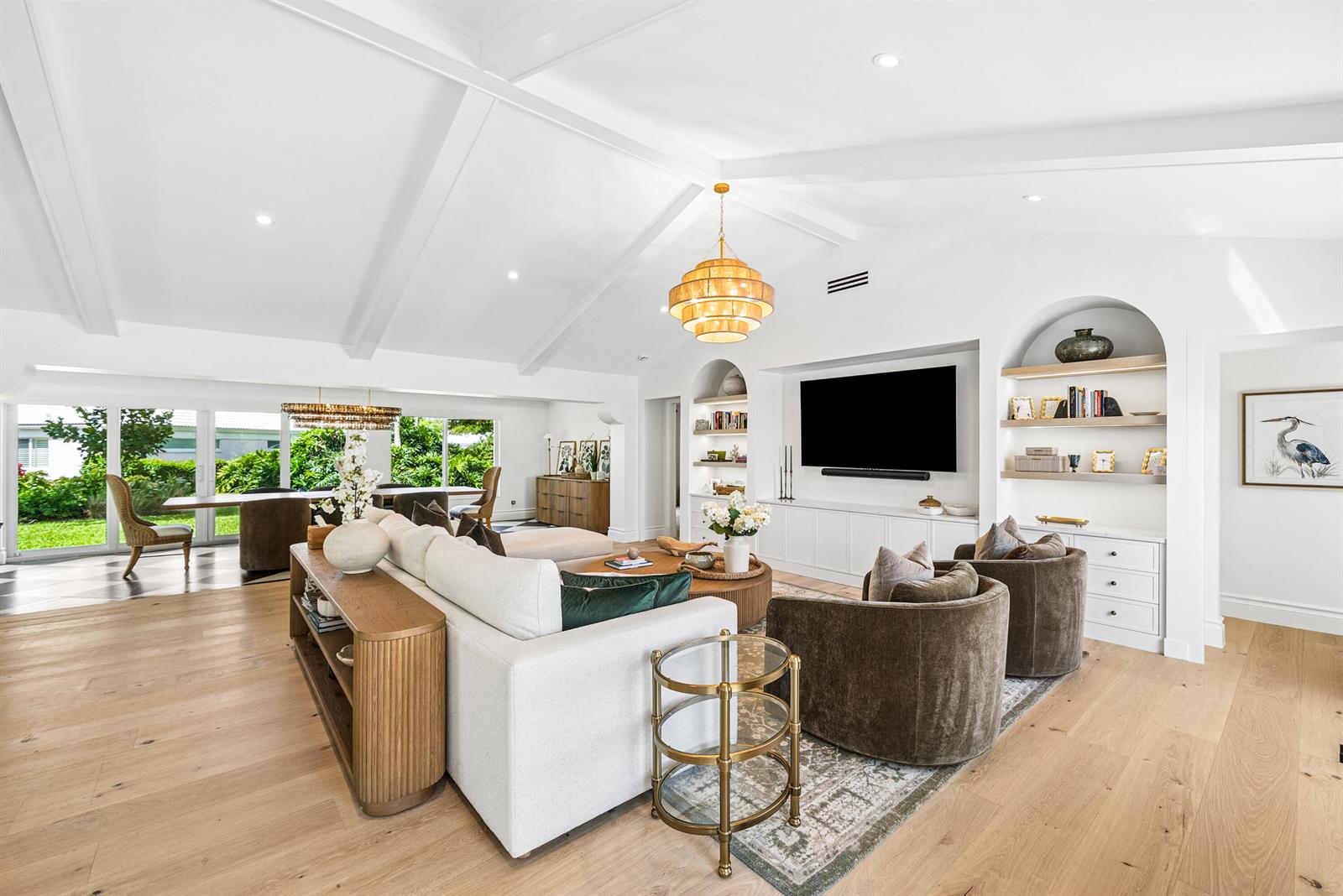 A bright living room features vaulted ceilings, a large sectional, and built-in arched shelving — 4419 E Sanderling Cir, Boynton Beach FL 33436, BOYNTON BEACH, FL