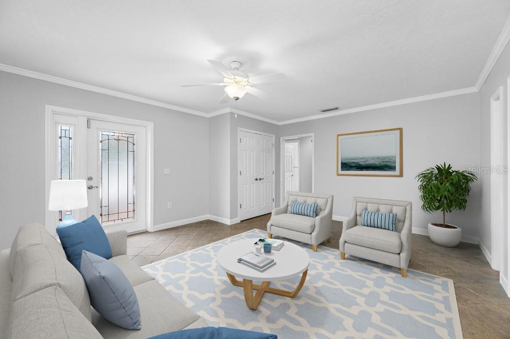 A living room features a gray sofa, two armchairs, a coffee table, and a front door — 10308 SANDPIPER ROAD W, BRADENTON, FL
