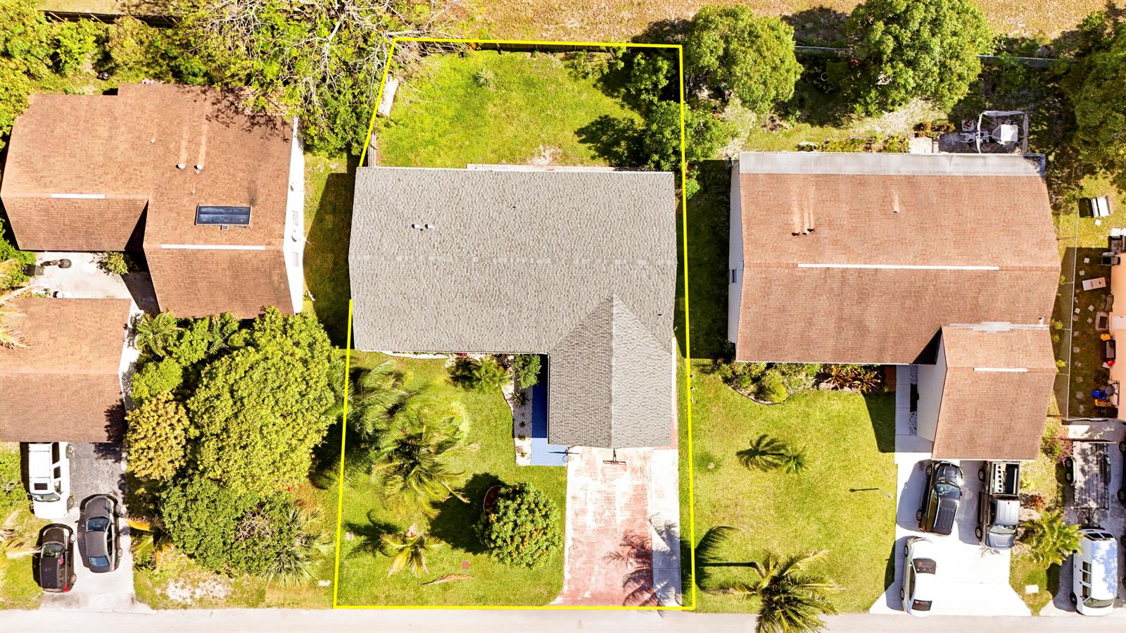 An aerial view shows a single-story house with a gray roof and a paved driveway — 3336 Ave Villandry, Delray Beach FL 33445, DELRAY BEACH, FL