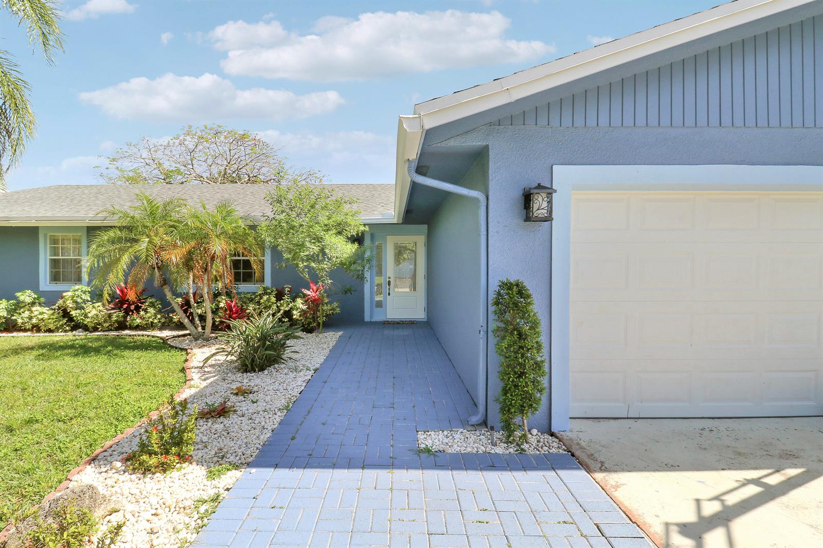A blue house with a paved walkway leading to the front door and a garage — 3336 Ave Villandry, Delray Beach FL 33445, DELRAY BEACH, FL