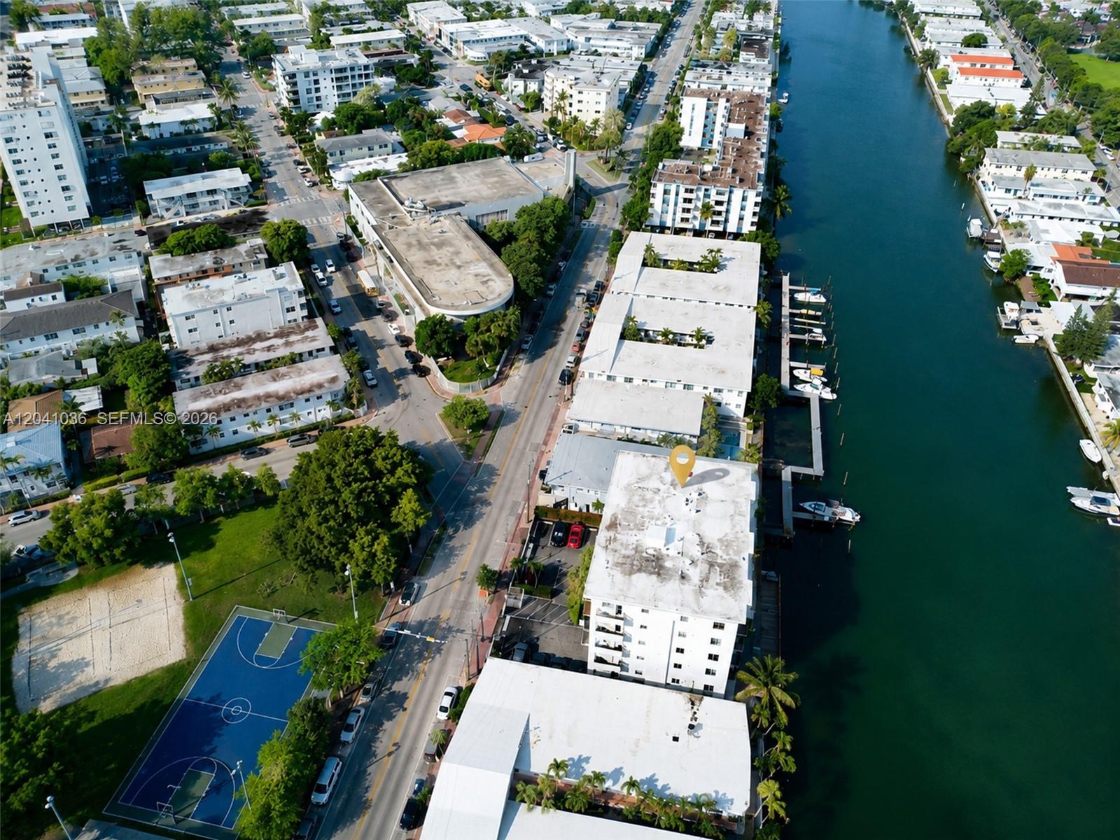 An aerial view shows a multi-story apartment building with a yellow location pin — 8024 Tatum Waterway Dr # 2B, Miami Beach FL 33141, MIAMI BEACH, FL