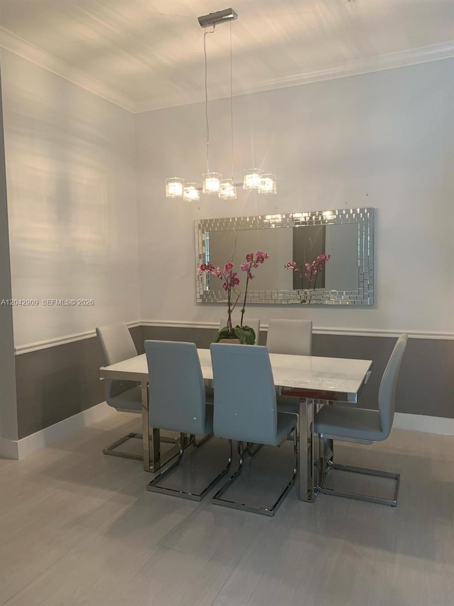 A dining room features a white table, six gray chairs, and a rectangular wall mirror — 4602 SW 160th Ave # 521, Miramar FL 33027, MIRAMAR, FL