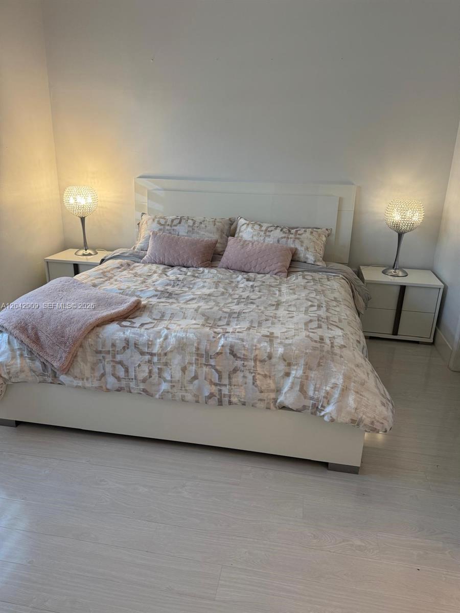 A bedroom features a white bed frame, patterned bedding, two nightstands, and matching crystal lamps — 4602 SW 160th Ave # 521, Miramar FL 33027, MIRAMAR, FL