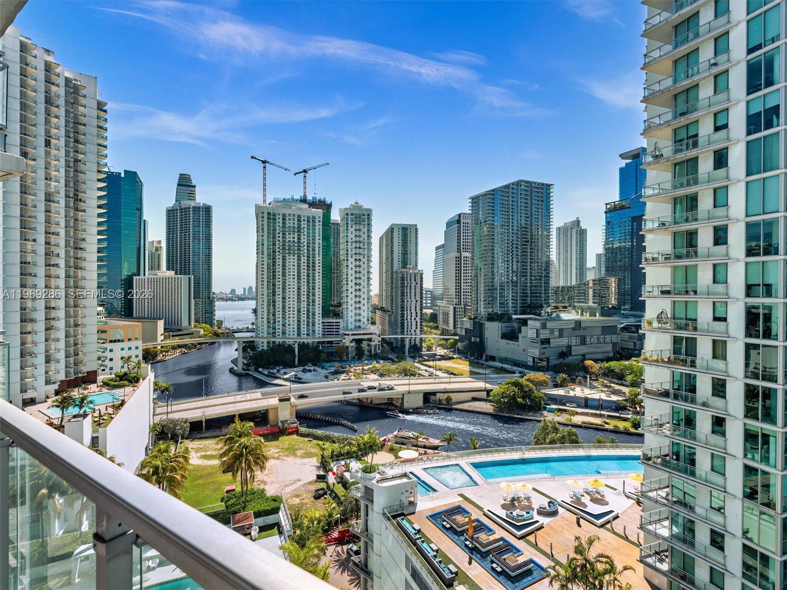 A high-angle view of a city skyline featuring skyscrapers, a river, and a swimming pool — 90 SW 3rd St # 2013, Miami FL 33130, MIAMI, FL
