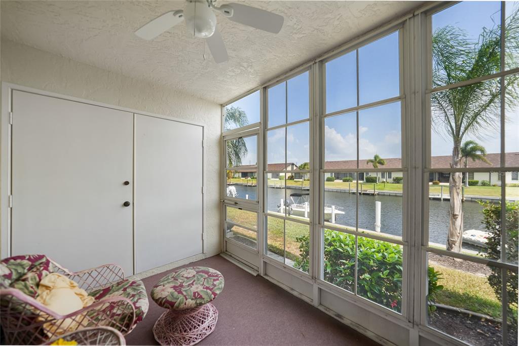 A screened-in porch with a ceiling fan overlooks a canal with a boat dock — 4000 BAL HARBOR BOULEVARD UNIT 214, PUNTA GORDA, FL