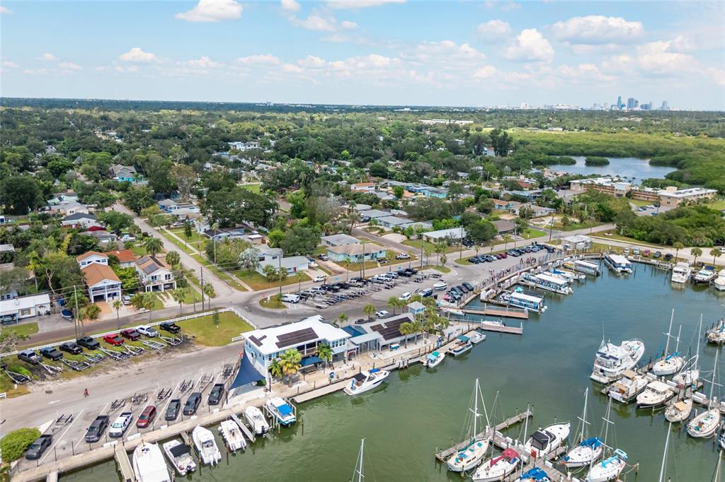 An aerial view shows a marina with docked boats, a parking lot, and surrounding residential homes — 2800 TIFTON STREET S, GULFPORT, FL