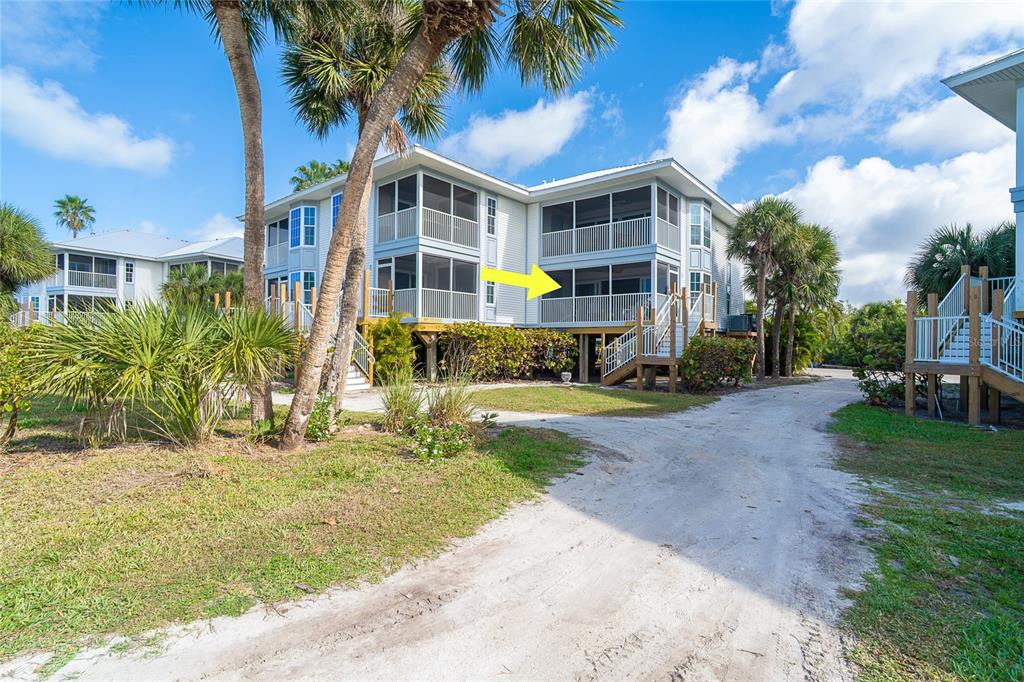 A multi-story building with screened-in balconies and a yellow arrow pointing to a unit — 7446 PALM ISLAND DRIVE UNIT 3511, PLACIDA, FL