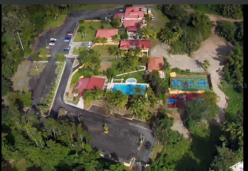 An aerial view shows a resort property with multiple buildings, a swimming pool, and tennis courts — CARR 1,  KM 21.3 BO. LA MUDA, GUAYNABO, PR