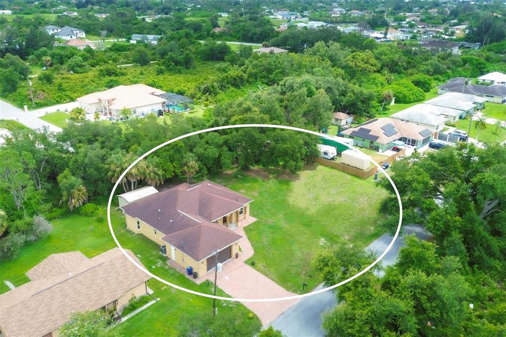 An aerial view shows a single-story house with a brown roof and large grassy yard — 431 SEVILLA STREET, NORTH PORT, FL