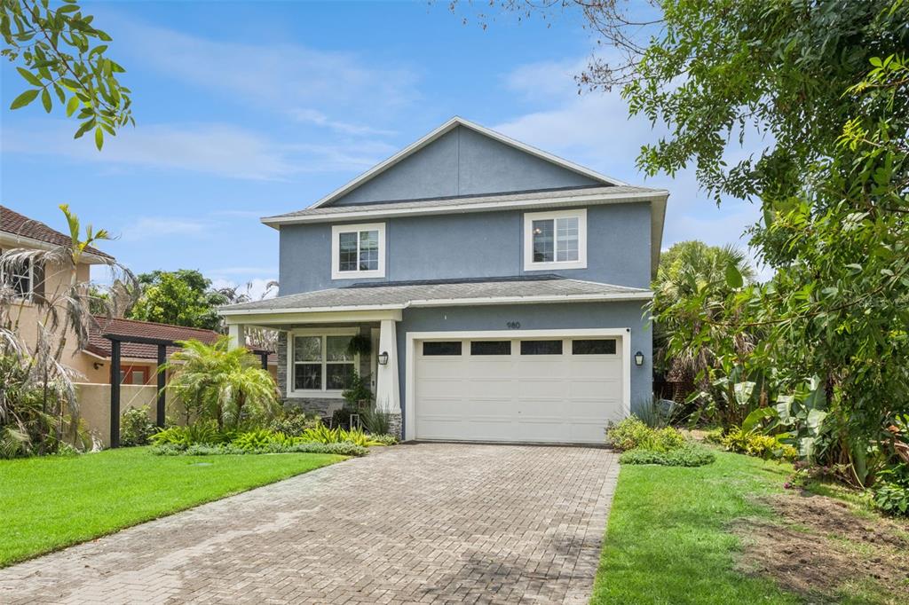 A two-story blue house with a white garage door and a paved driveway — 980 BURNS STREET, ORLANDO, FL