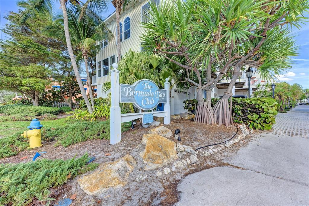 A sign for The Bermuda Bay Club stands in front of a multi-story building — 1469 GULF DRIVE N, BRADENTON BEACH, FL