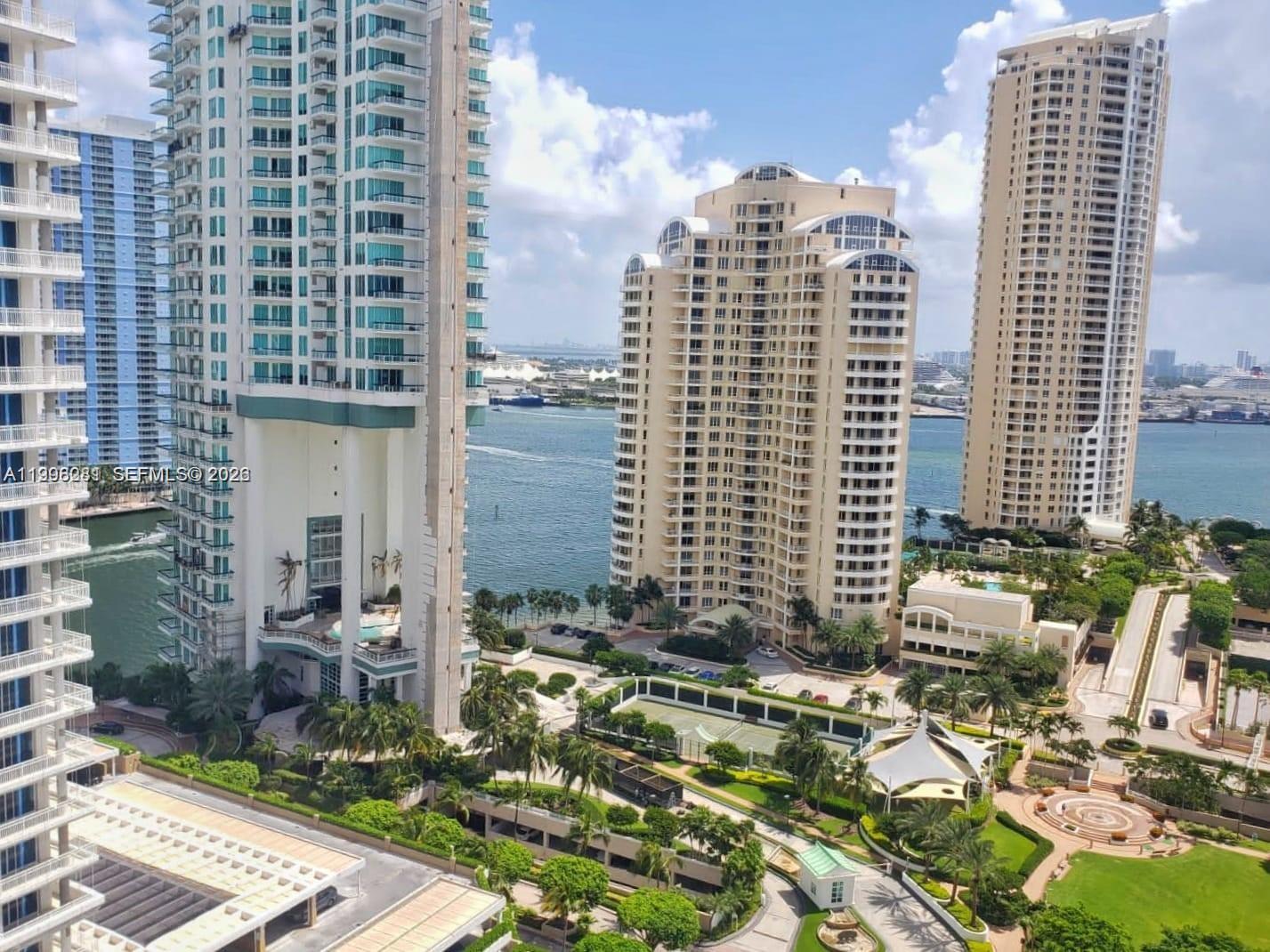 An elevated view of high-rise apartment buildings overlooking a bay with landscaped grounds below — 701 Brickell Key Blvd # 2306, Miami FL 33131, MIAMI, FL
