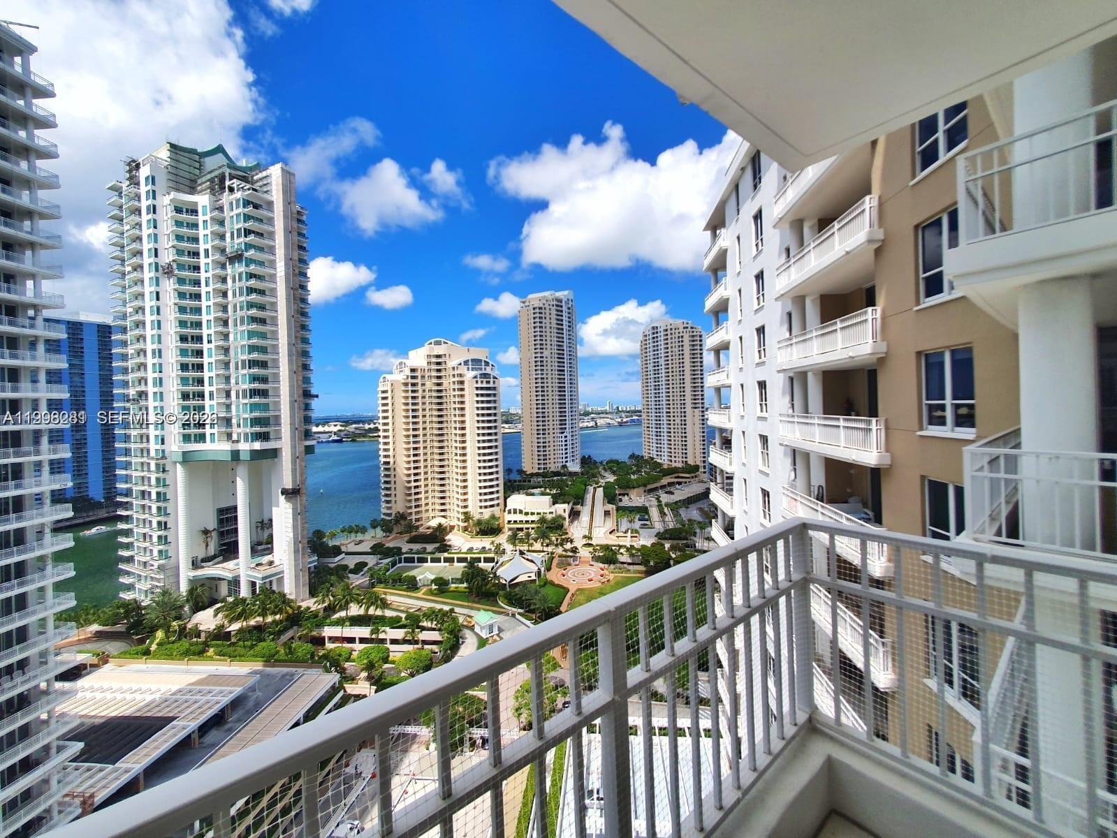 A high-rise balcony view overlooks a waterfront complex with multiple tall residential towers — 701 Brickell Key Blvd # 2306, Miami FL 33131, MIAMI, FL