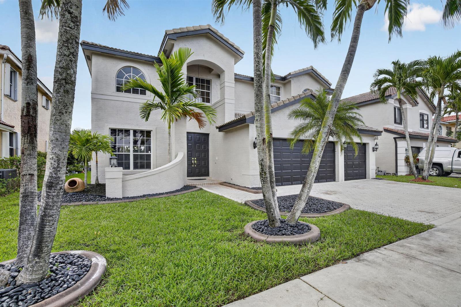 A two-story suburban house features a stucco exterior, a three-car garage, and palm trees — 3535 SW 177th Avenue, Miramar FL 33029, MIRAMAR, FL